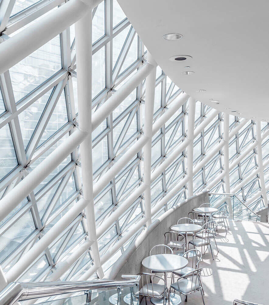Daylit commercial interior beneath a glazed roof structure